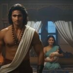Screenshot from JioHotstar’s AI Mahabharat Ek Dharmayudh trailer showing a warrior entering a royal chamber, while a woman holds a baby in the background.
